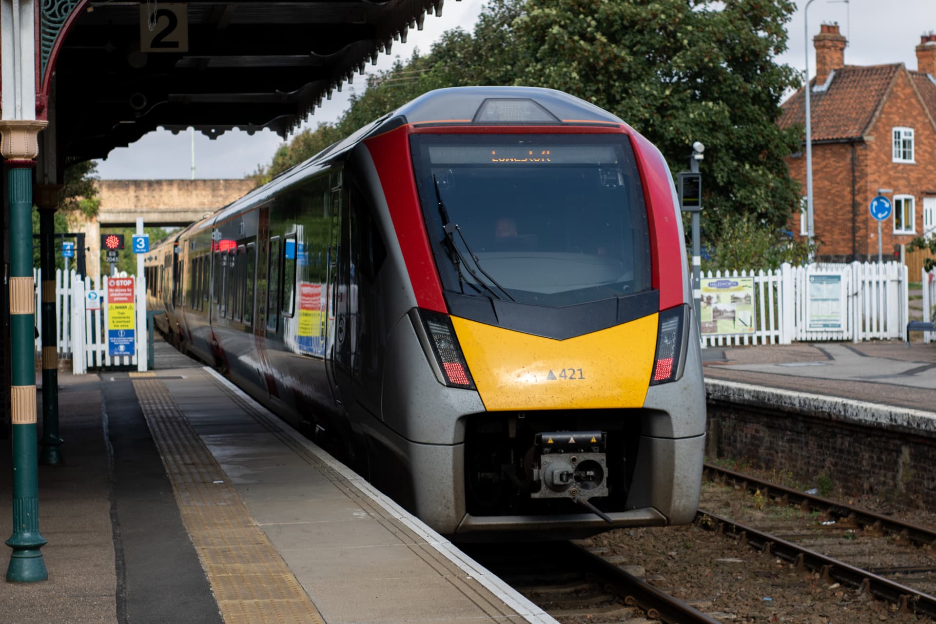 Modern passenger train waiting at a UK station platform