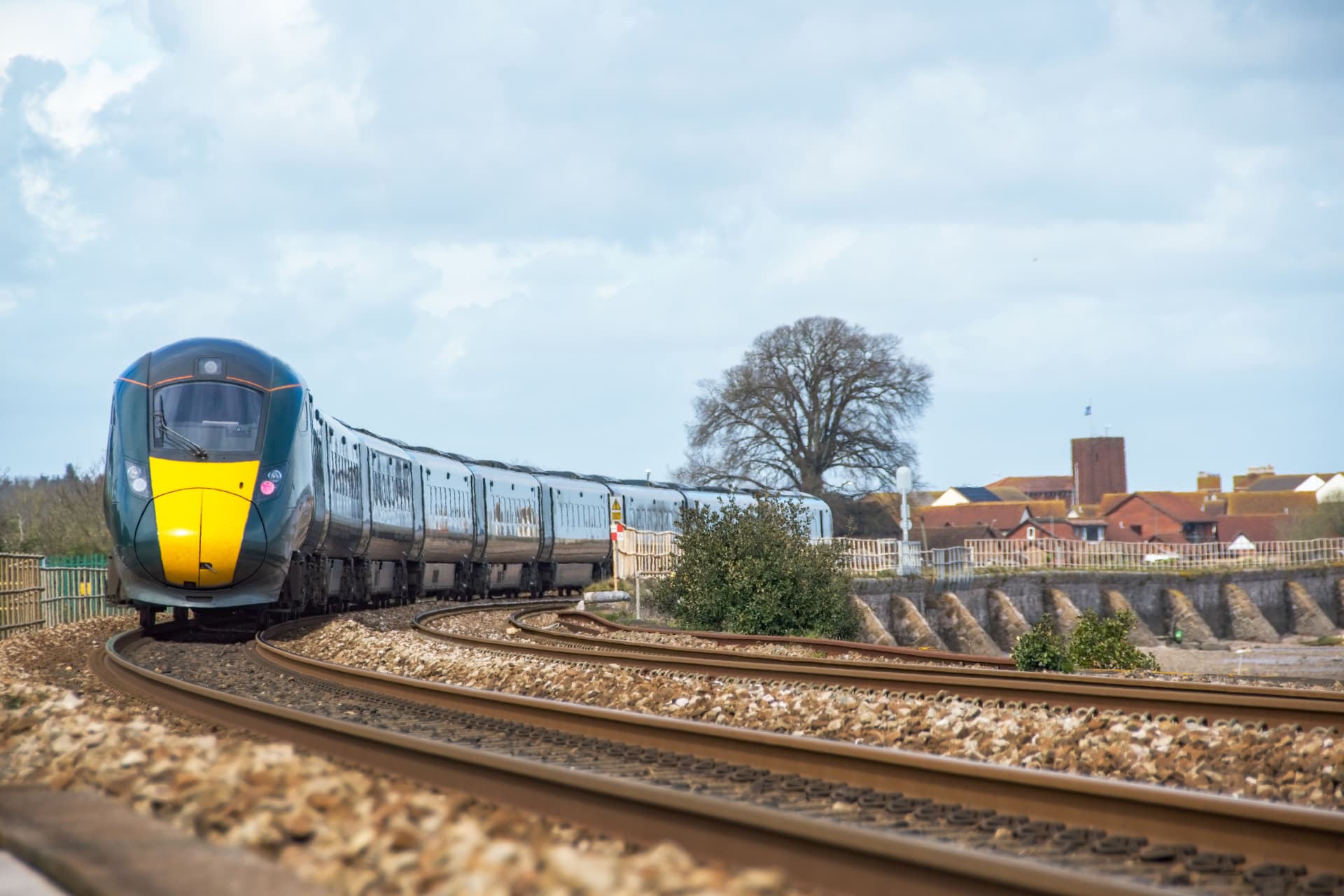 Intercity train rounding a coastal curve in the UK